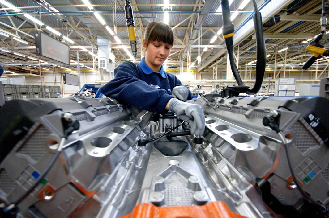 Woman working on engine production line