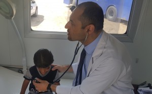 Dr Laith AlRubaiy treating a young child